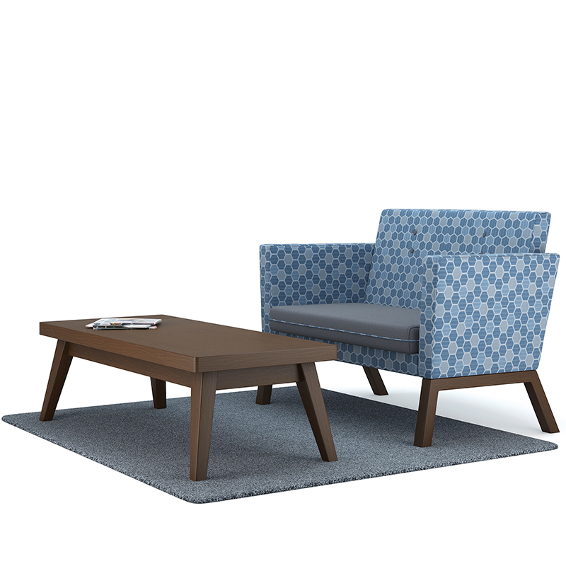 Dark wooden rectangular table with blue geometric patterned sofa