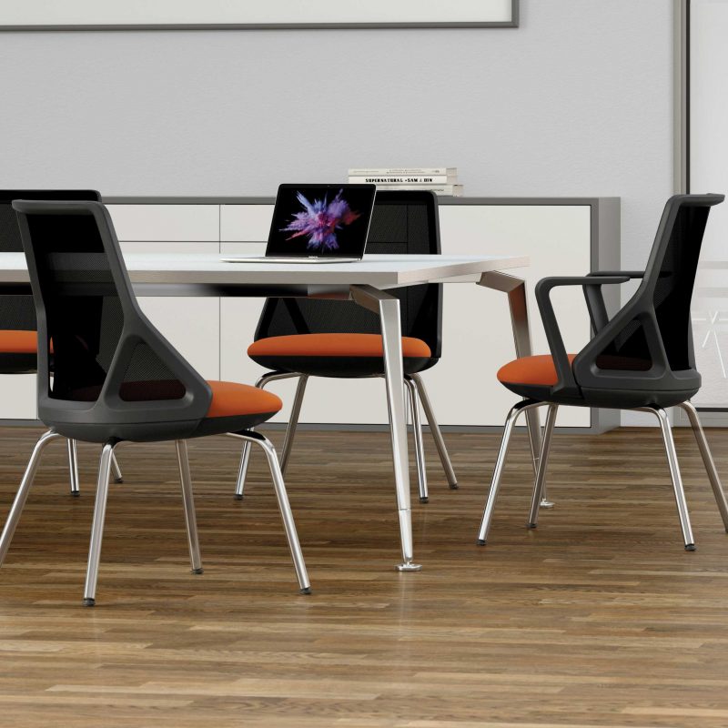 Black and orange meeting chairs around a white table